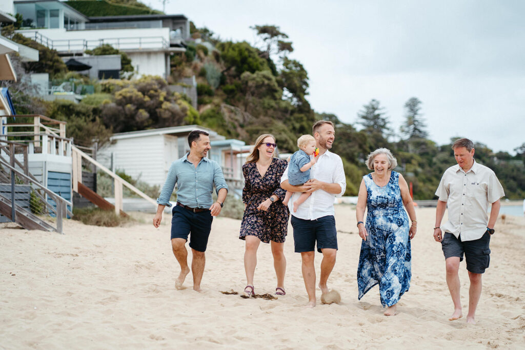 a family walks along the beach in Melbourne Bayside