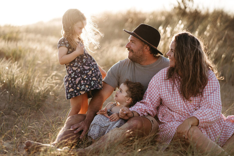 a family of four at golden hour at the beach in Gippsland, Victoria