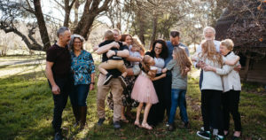 a large family group mucks around with each other