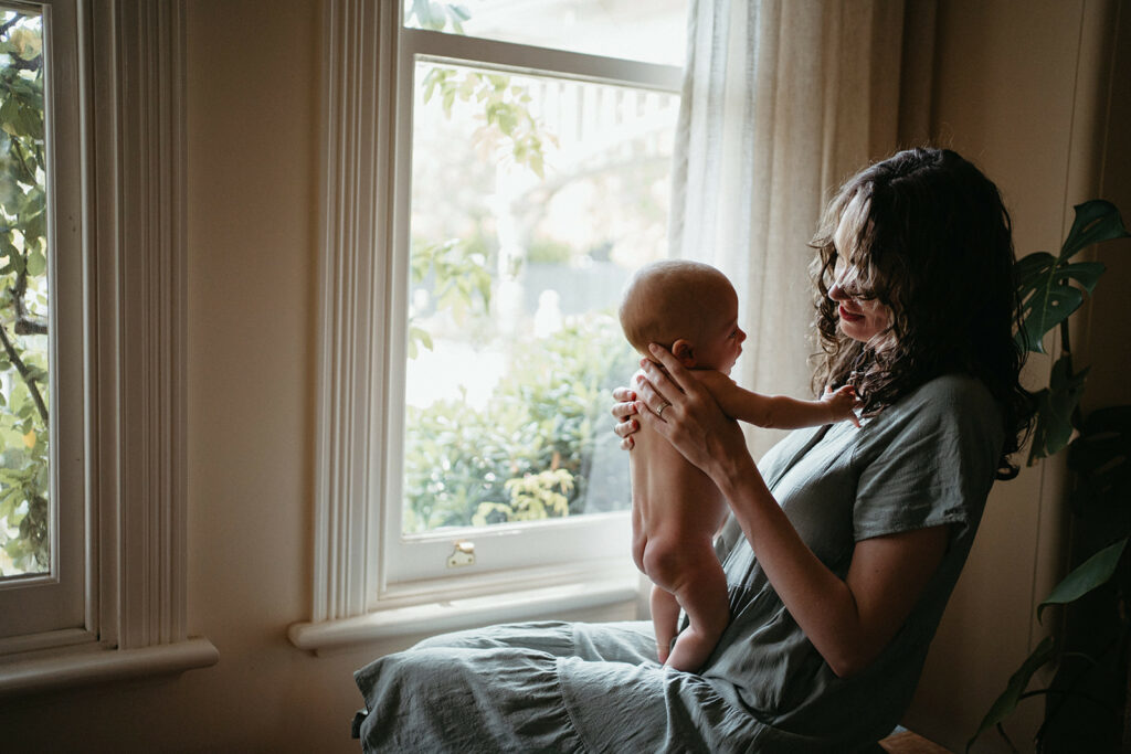 a mother holds her newborn son melbourne newborn photography session