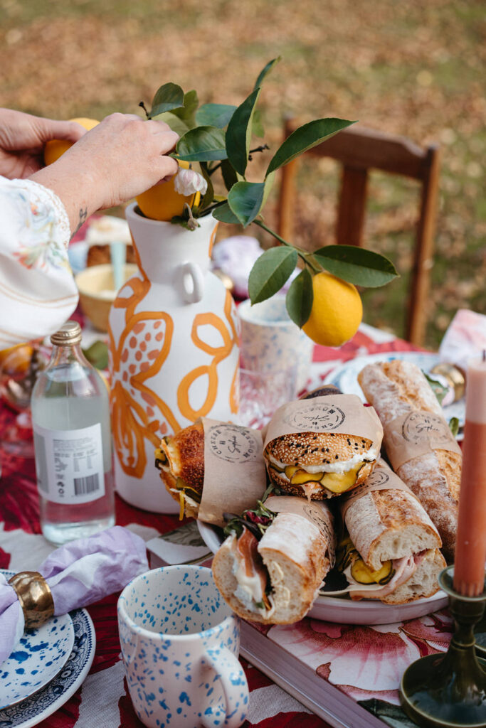hand adjusting a tablescape food image for womens clothing store brand photography in melbourne