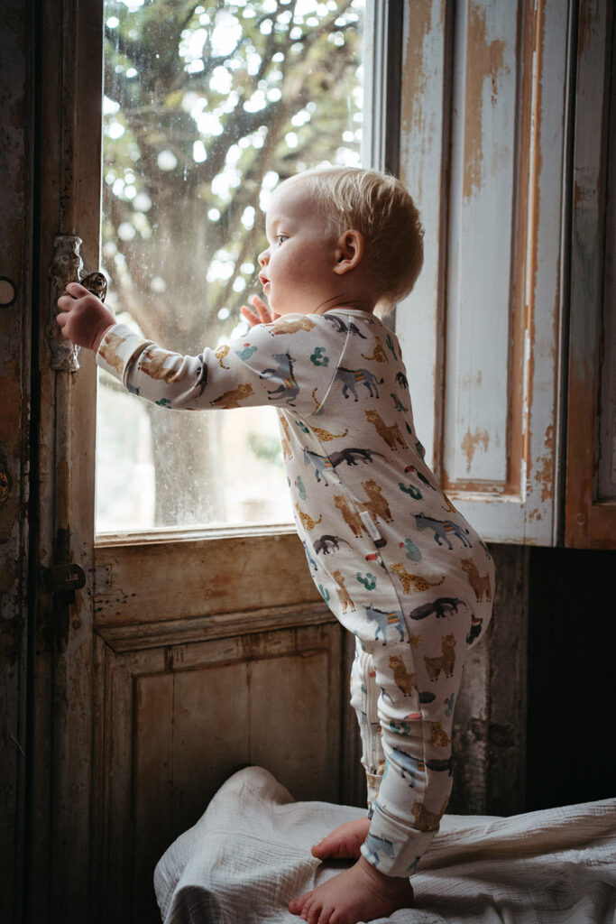 baby boy wearing purebaby onesie at a brand shoot for kids clothing company