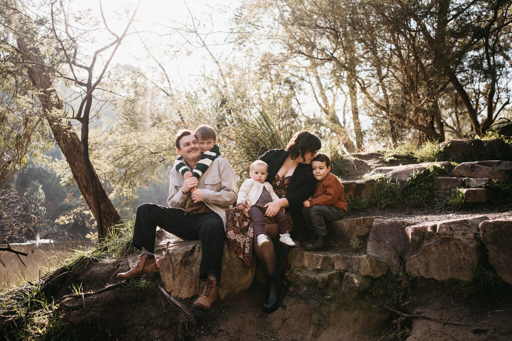 a family photoshoot on rocks near warrandyte river