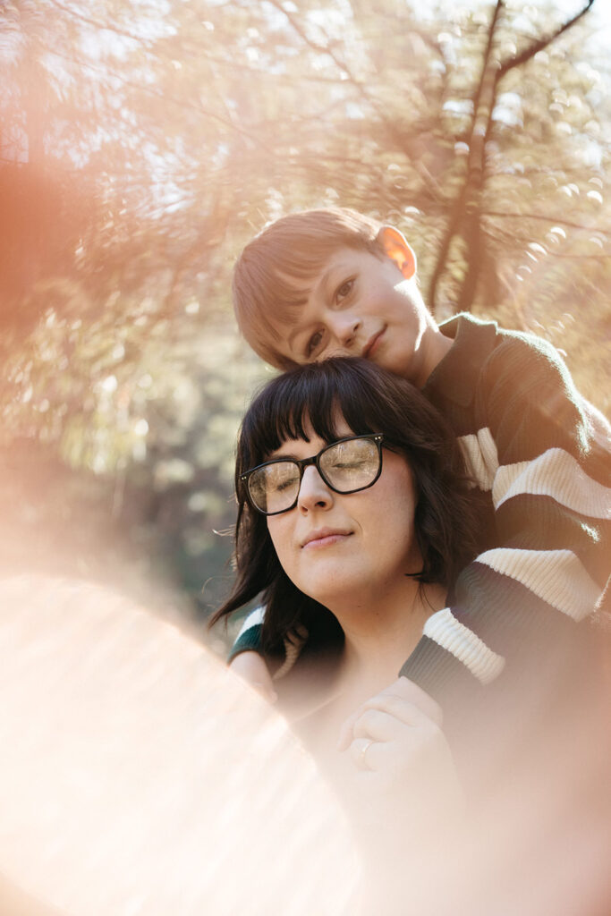 a portrait of a mother with her young son leaning over her during a family photoshoot with Bec Matheson Photography