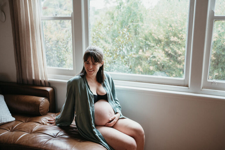 pregnant woman sitting in window